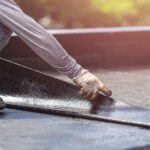 group-of-worker-installing-tar-foil-on-the-rooftop-of-building-waterproof-system-by-gas-and